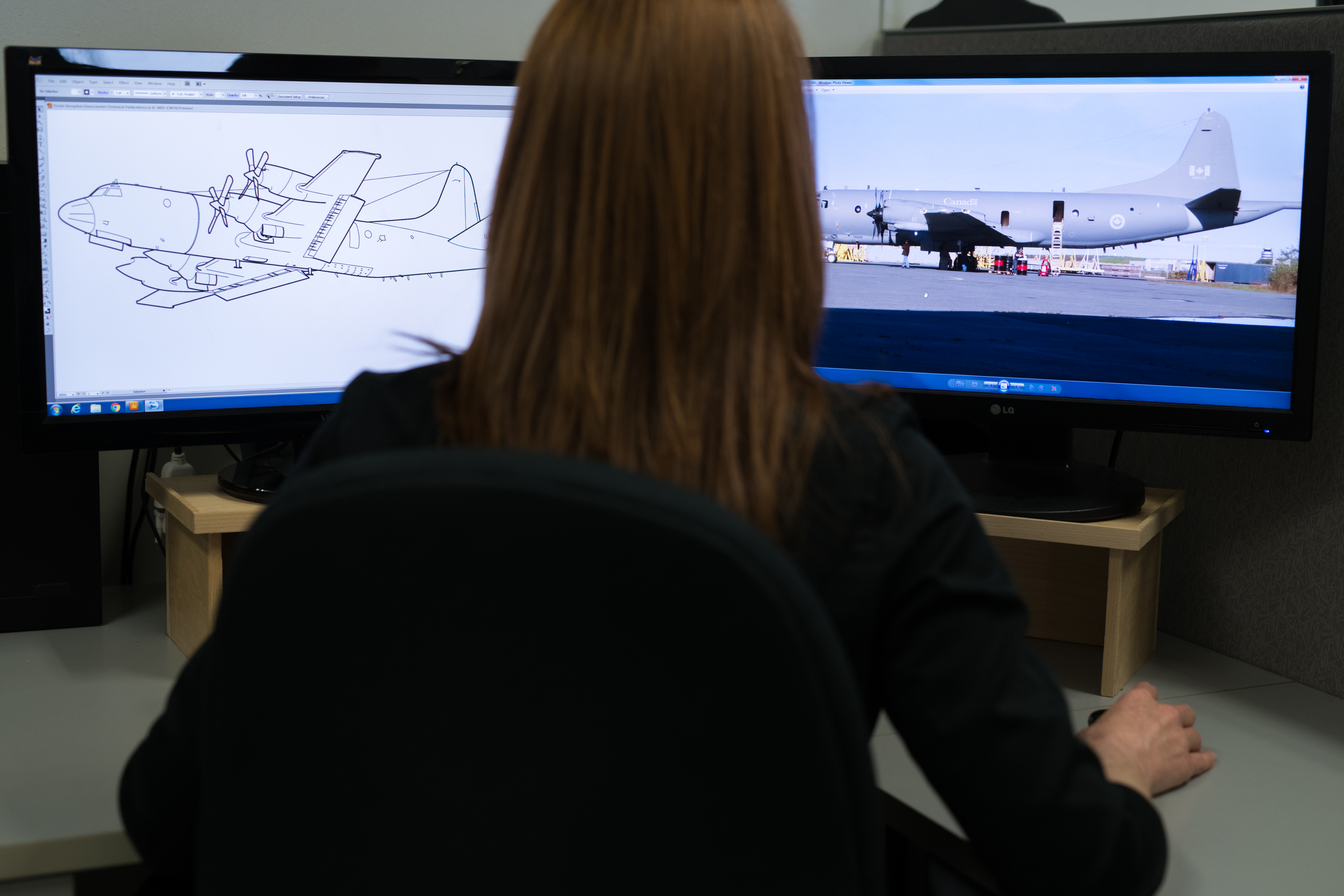 View of two computer monitors displaying aircraft designs