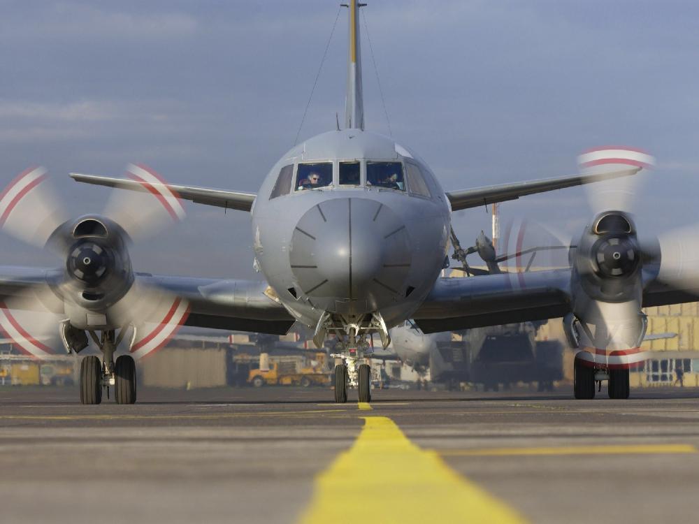 Front view of an aircraft coming down a runway