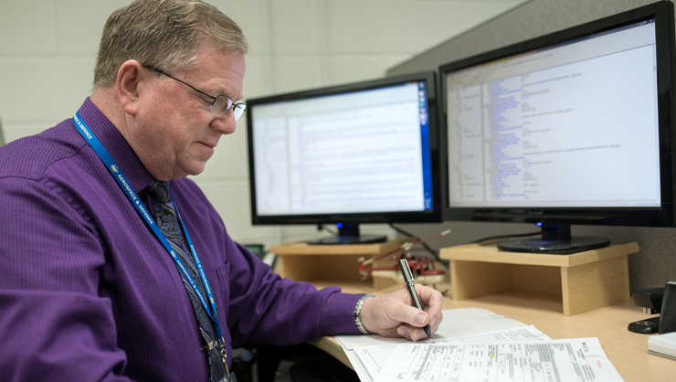 Management team member performing logistics support analysis